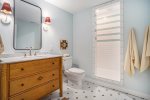 The Lower Level Entertainment Hub Adds Even More Convenience with an Adjoining Bathroom